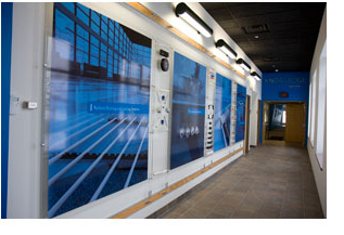 A hallway in the newly renovated Uponor Factory Training Center features bold, blue images of radiant, plumbing and fire sprinkler applications.
